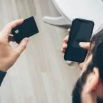 Phone payment screen representing CBDC and stablecoin comparison